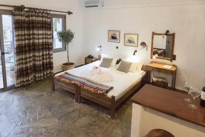 a bedroom with a bed and a table and a mirror at Flamingos Hotel Apartments in Kato Daratso