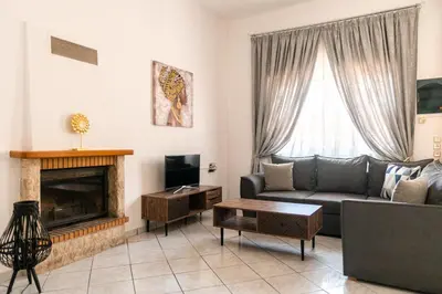 a living room with a couch and a fireplace at Peggy's apartment in Chania in Chania Town