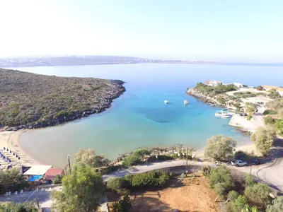 an aerial view of a beach with boats in the water at Tersanas Beach Apartments in Chorafakia