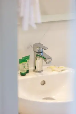 a bathroom sink with a faucet and toothpaste at Falasarna Bay in Falasarna