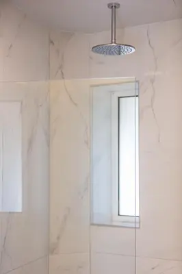 a shower with a glass door and a window at Falasarna Bay in Falasarna