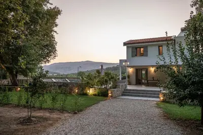 a house with a pathway leading to the front yard at Villa Nature, Heated Pool in Kalyves