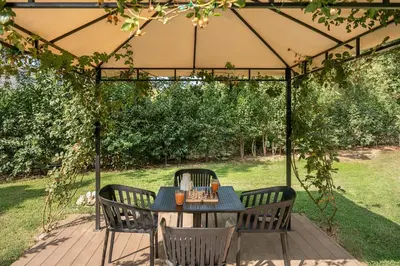a table and chairs under a tent in a yard at Villa Nature, Heated Pool in Kalyves
