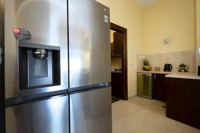 a large stainless steel refrigerator in a kitchen at Villa Leon in Souda