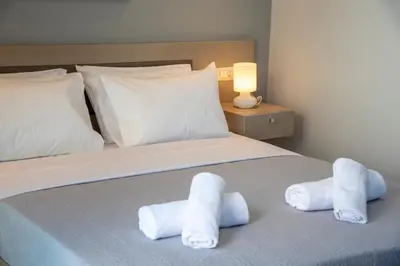 a bedroom with a bed with towels on it at Sunshine Suite Family in Chania Town