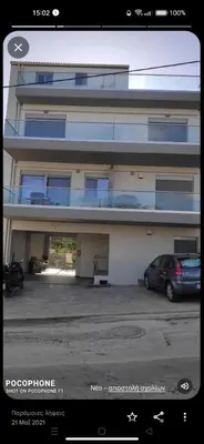 a building with a car parked in a parking lot at Sunshine Suite Junior in Chania Town