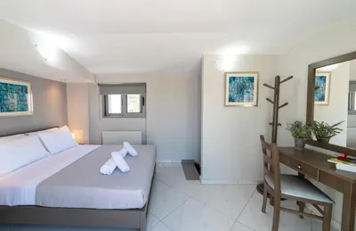 a hotel room with a bed and a desk and a desk at Sunshine Suite Junior in Chania Town