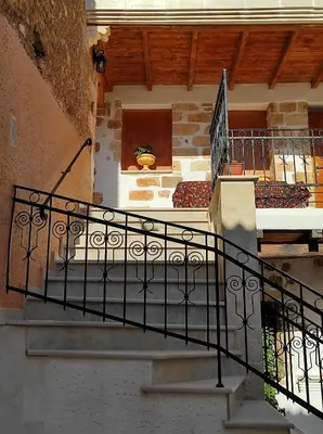a staircase in a building with a stair railing at Castello casa in Perivólia