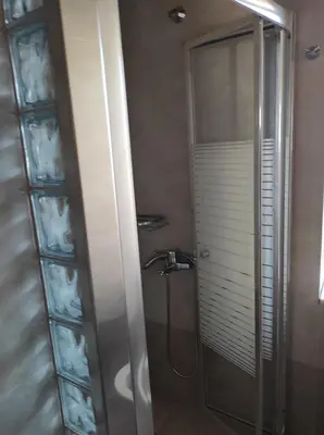 a bathroom with a shower with a glass door at Castello casa in Perivólia