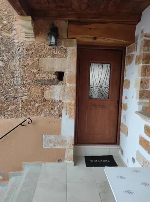 a door in a building with a stone wall at Castello casa in Perivólia