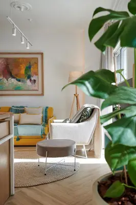 a living room with a couch and a chair at KaiZen Chania - New Central Apartment Just 350m Away With Private Jacuzzi and free parking! in Chania Town