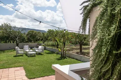 a backyard with a table and chairs and trees at Eos Studio in Chania Town