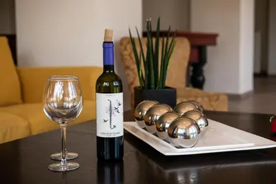 a bottle of wine and a glass on a table at Eos Studio in Chania Town