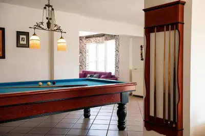 a pool table in a living room with at Eos Studio in Chania Town