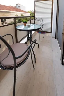 a balcony with a table and chairs on a balcony at Eleni's apartment in the center of Chania in Chania Town