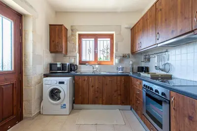 a kitchen with a washing machine and a sink at Villa Daya in Darmarochori