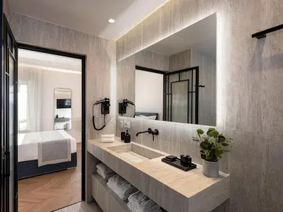 a bathroom with a sink and a mirror at Riviera Suites in Chania Town