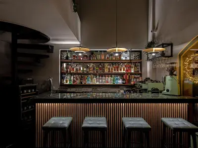 a bar with four stools in front of it at Riviera Suites in Chania Town