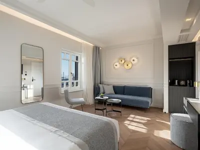 a hotel room with a bed and a couch at Riviera Suites in Chania Town