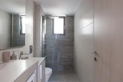a bathroom with a shower and a toilet and a sink at Aurora apartments in Chania Town
