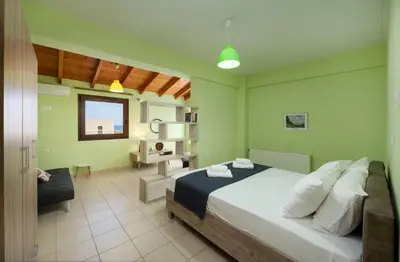 a bedroom with a bed and a desk in it at Villa Flora by PosarelliVillas in Módhion