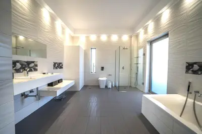 a bathroom with two sinks and a tub and a shower at La Maison Du Soleil Luxury Villa by 8essentially in Varípetron