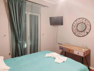 a bedroom with a bed and a mirror and a table at Art and view-studio in Kounoupidhianá