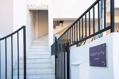 a stairway with a sign that reads west city at West City Suite in Chania Town