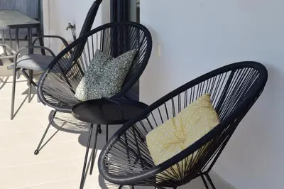 a group of chairs with pillows on them at Zoe's Luxury Home - Private Parking in Chania Town