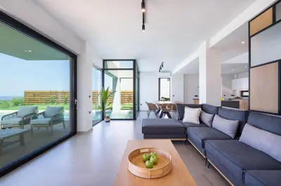 a living room with a couch and a table at Avra & Ostria Villa, Pirgos-Villas,Heated pool , amazing sea view in Maleme