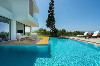 a swimming pool next to a house at Avra & Ostria Villa, Pirgos-Villas,Heated pool , amazing sea view in Maleme