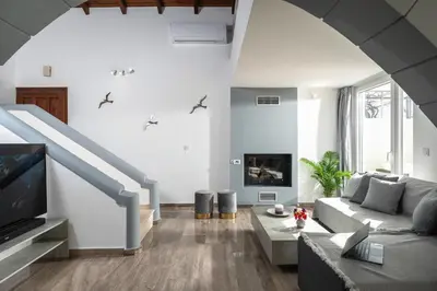 a living room with a couch and a tv at OLIVE ANGEL in Chania Town