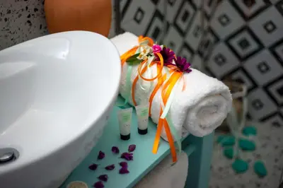 a close up of a toilet with towels and flowers at Trigono Traditional House in Kalivianí