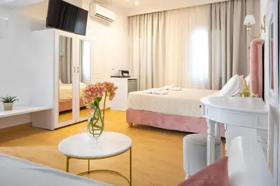 a hotel room with a bed and a table with a sink at Vener Suites in Chania Town