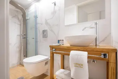 a bathroom with a sink and a toilet and a shower at Vener Suites in Chania Town