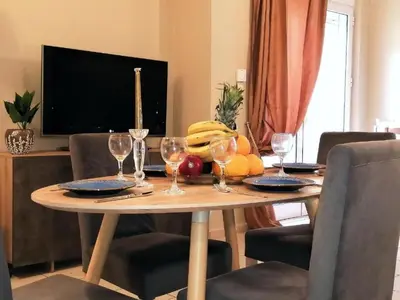 a wooden table with wine glasses and fruit on it at Odyseia Apts ΙI at the Center of the City & Old Town in Chania Town