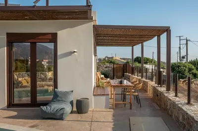 a house with a patio with a table and chairs at Sia Elafonisi Pool House in Elafonisi