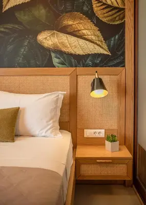 a bedroom with a bed and a lamp on a table at Sia Elafonisi Pool House in Elafonisi