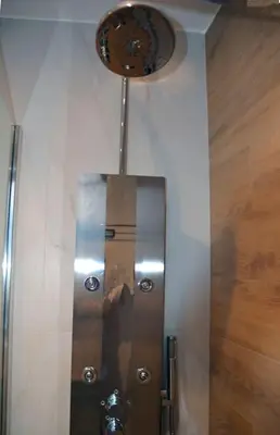 a shower stall with a metal door in a bathroom at Cozy Val in Chania Town