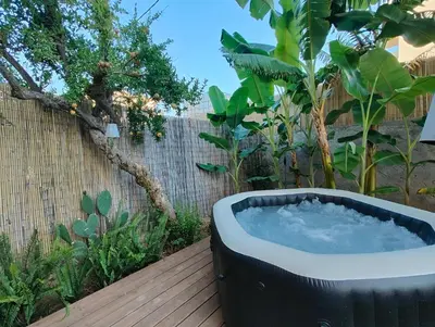 a bath tub sitting on a wooden deck at m&m's city loft in Chania Town