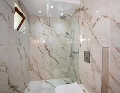 a bathroom with a marble shower with a toilet at Nicole Villa I 