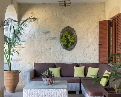 a living room with a couch and a stone wall at Nicole Villa I 