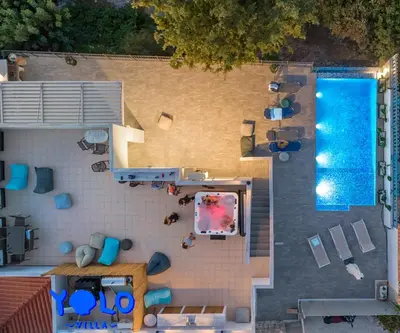 an overhead view of a swimming pool and a house at Villa YOLO in Almirida