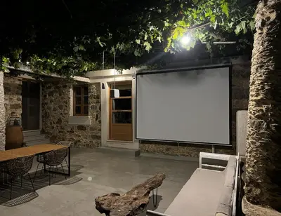 a large white screen on the side of a building at The Stone House in Avdhoulianá