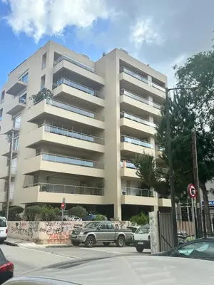 an apartment building with cars parked in front of it at W Apartment in Chania Town