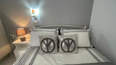 a bedroom with a bed with pillows and a lamp at Gesthimani's Residence in Áyios Yeóryios