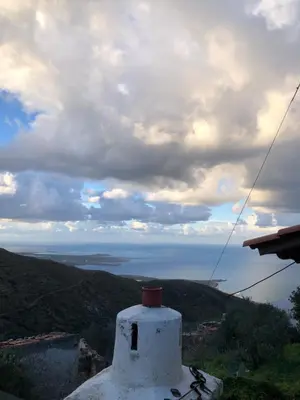 a view of the ocean from the top of a building at ARETI Sea View Mountain Cottage in AmigdhalokeFálion