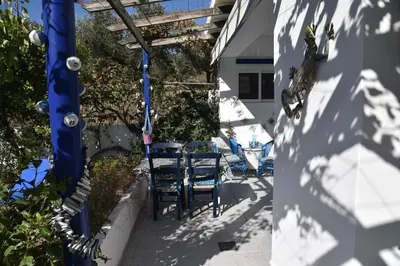 a patio with chairs and a table in a building at Relaxing and Comfortable Studio Near Falasarna Beaches in Plátanos