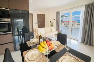 a dining room with a table with fruits and wine glasses at Home Sweet Home - Big Balcony with Great View in Kissamos