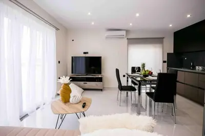 a living room with a table and a dining room at Home Sweet Home - Big Balcony with Great View in Kissamos